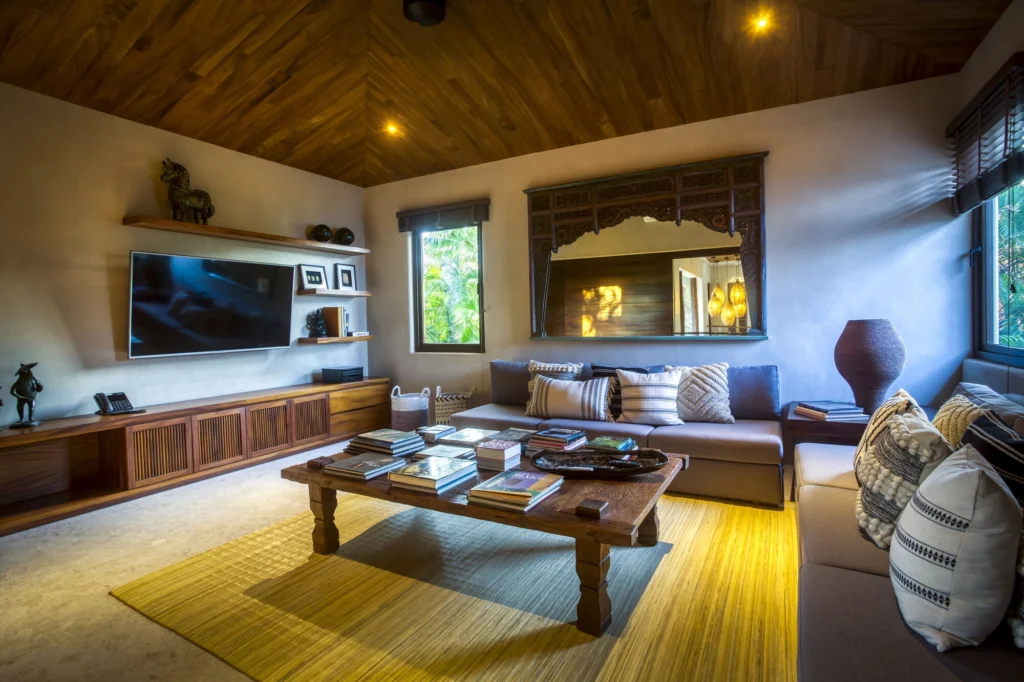 Television lounge at Casa Dewi with sofas and a warm timber ceiling