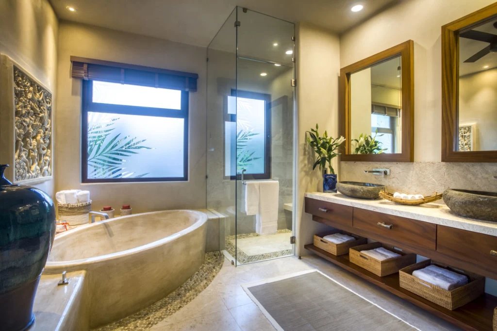 Casa Dewi bathroom with a soaking tub, glass shower and double natural-stone vanity