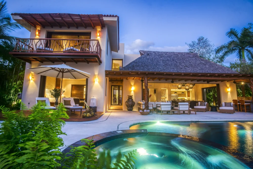 Casa Dewi illuminated at dusk beside the swimming pool and circular spa
