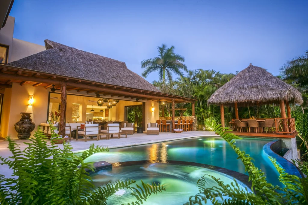 Casa Dewi pool and circular spa at dusk beside the covered lounge and palapa dining pavilion