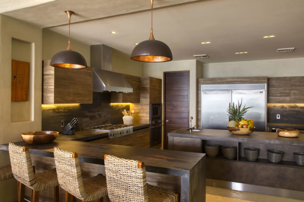 Spacious Casa Dewi kitchen with a cooking range, island, bar seating and full-height refrigerator