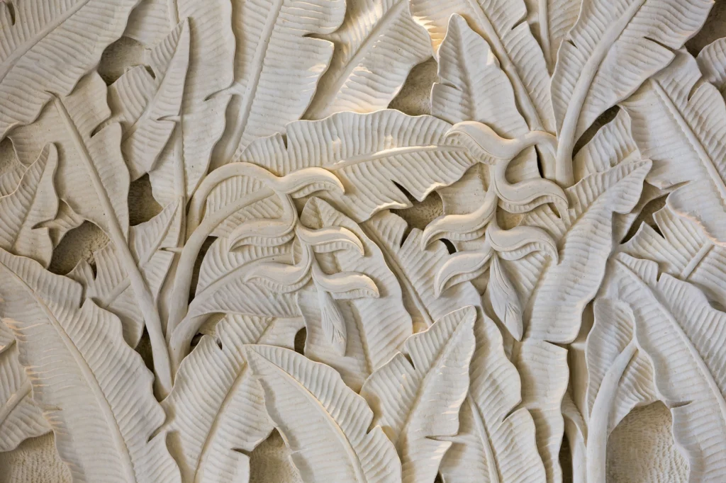 White carved panel with tropical birds and leaves at Casa Dewi