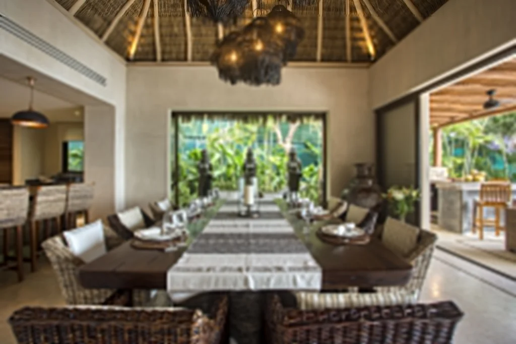 Dining room at Casa Dewi opening to the kitchen, terrace and tropical garden