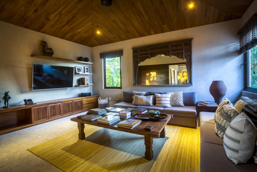 Media room at Casa Dewi with two sofas, a television and a timber ceiling
